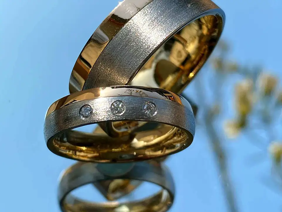 Two-tone gold and platinum wedding bands with small diamonds
