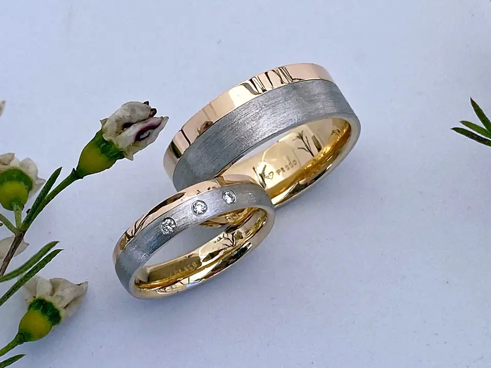 Handmade two-tone wedding bands set with diamonds
