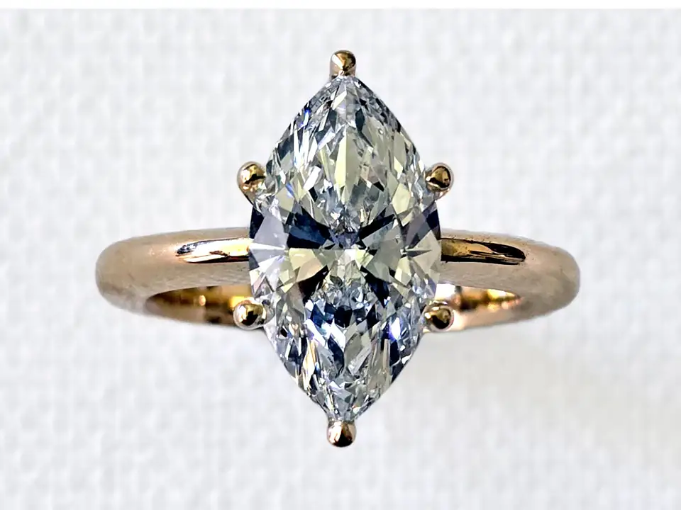 Solitaire ring with a marquise diamond in a gold setting